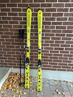 Front view of Rossignol 9X skis and Head poles leaning against wall