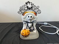 Front view of Jack Skellington wax warmer with pumpkin accent and topper