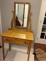 Front view of vanity showing overall design, drawer, mirror