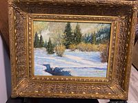 Front view of framed winter landscape painting showing artwork and signature