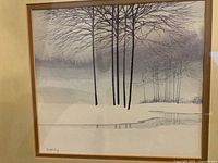 Close view of pastel artwork showing winter trees, snow and water