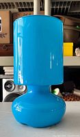 Front view of bright blue Ikea Lykta glass table lamp