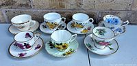 Group shot of seven teacup & saucer pairs