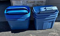Two stacks of blue plastic totes with nested lids