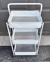 Front view showing three trays and handle