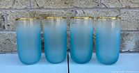 Front view of all four Blendo turquoise frosted tumblers