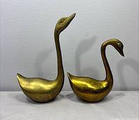Both brass swans front view