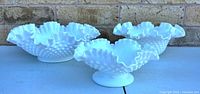 Three hobnail milk-glass bowls front view
