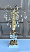 Full view of brass waterfall crystal lamp front
