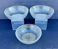 Three clear textured glass bowls front view