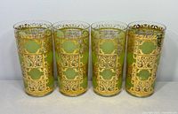Front view of four Culver Prado green highball glasses