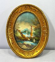 Front view of framed oval oil painting