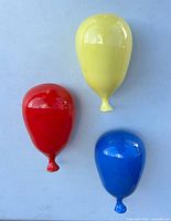 Front view of three ceramic balloons on wall