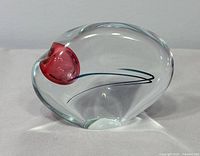 front view showing pink orb and swirl lines inside clear glass