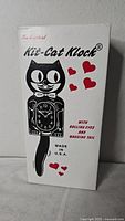 Front of boxed Kit-Cat Klock showing branding, features, and made in USA mark