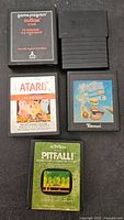 Five Atari 2600 cartridges arranged; labels visible on four, one label worn