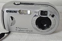 Front view showing lens, flash, Sony branding and 4.1 megapixel marking