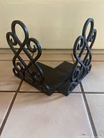 Pair of cast iron scrollwork bookends on tiled surface