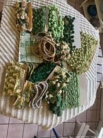 Overview of all green decorative trims laid out on surface