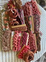 Overview of assorted fringe trims laid out on table