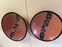 Both soapstone plates showing size difference and carved band