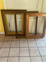 All three frames leaning against wall