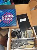Filament box, scanner, cables, power adapter and instruction booklet