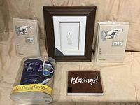 Front view showing two invitation packs, Blessings cards, Sharon Nowlan framed angel art, colour-changing mug in packaging
