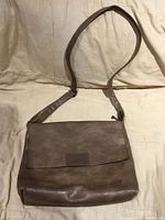 Full view of taupe Coveri Collection shoulder purse with flap closed