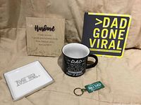 Front view showing tray, mug, book, plaque, keychain