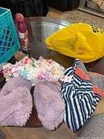 Floral dress, striped garment, purple slippers on table