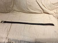 Full view of leather belt laid flat