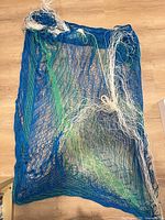 Full view of rectangular blue, green and white mesh net