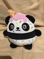 Front view of 6-inch panda ice-cream plush with pink icing and sprinkles