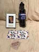 All items arranged: BottleKeeper, framed cork shadow box, two square coasters, round wooden opener in plastic