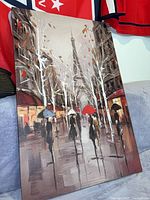 Full view of the unframed canvas painting showing the Paris street scene