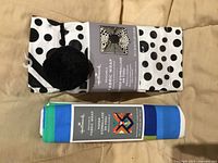 Front view showing both folded fabric wraps with packaging and visible patterns