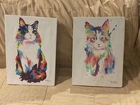 Front view of both watercolor cat paintings on canvas