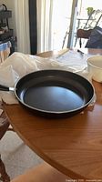 Top view of black non-stick crepe pan on table