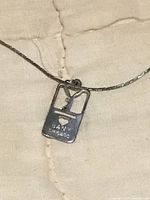 Close-up of Bany Chicago stamped bunny pendant on chain