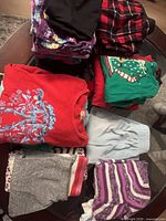 Pile of assorted girls clothing on table