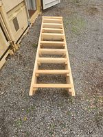 Top view of unfinished pine staircase showing open riser construction and nine treads