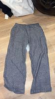 Full view of grey linen pants laid flat