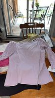 Light pink Northern Reflections long sleeve shirt displayed flat on table