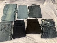 All six folded jeans showing assorted washes