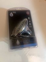 Front view of sealed Akuaplus shower head package