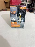 Front of sealed box showing brand, 60 W replacement, dimmable, 500 lm