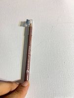 Full view of unused Annabelle medium brown eyebrow pencil with cap covering spoolie
