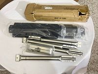 Cardboard box with black heat plates and stainless burner tubes