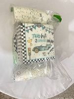 sealed set showing napkin front design and cups